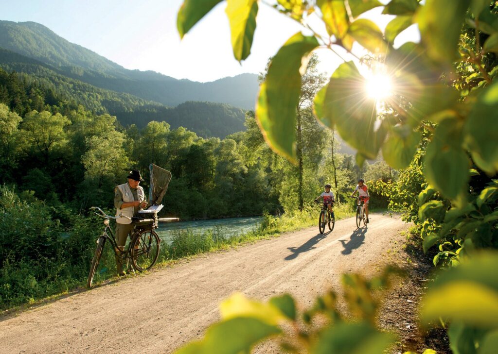 Cycling along the Drava River surrounded by green forests and peaceful countryside