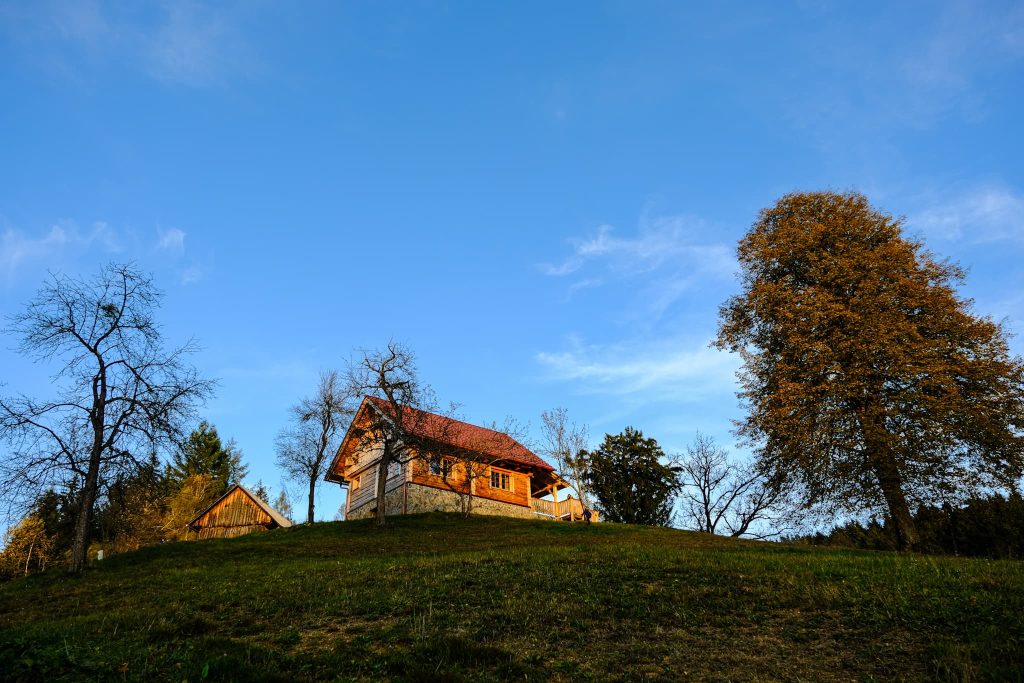 The house is located on a small hill and is surrounded by meadows and forests.