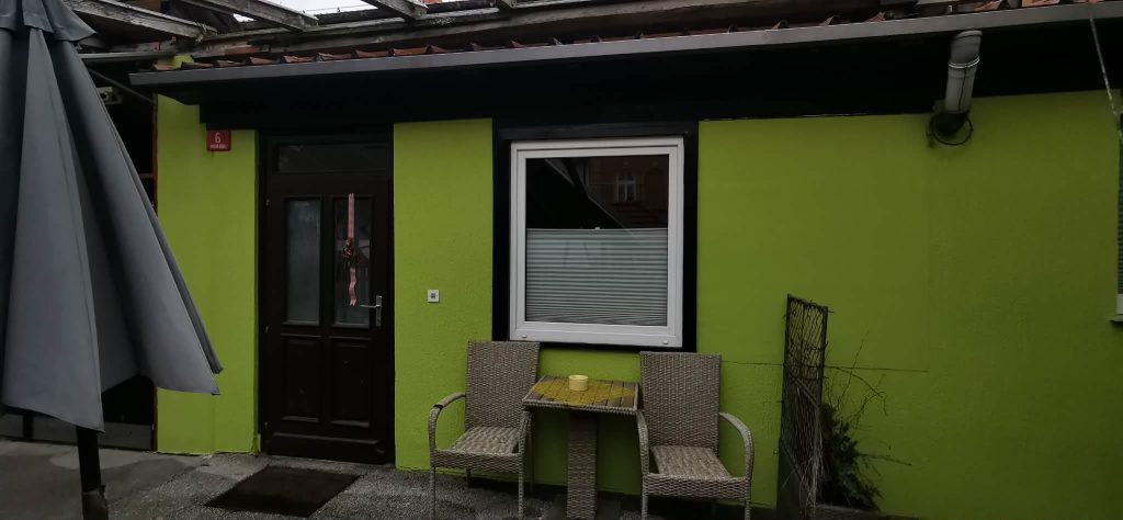 Entrance area with small outdoor seating where guests can sit and enjoy the fresh air.