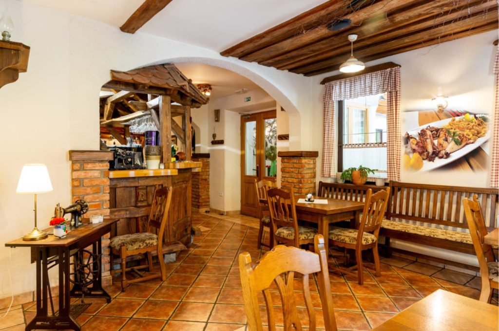 The interior of the inn welcomes visitors with a warm and cozy ambiance featuring wooden elements.