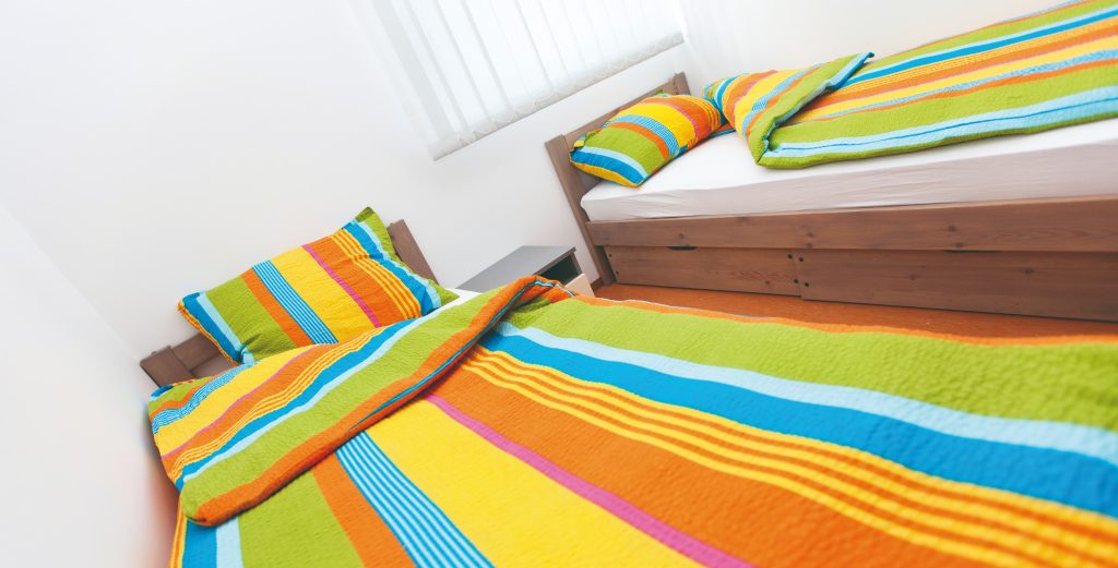 A bright and pleasantly furnished multi-bed room offers comfortable accommodation.
