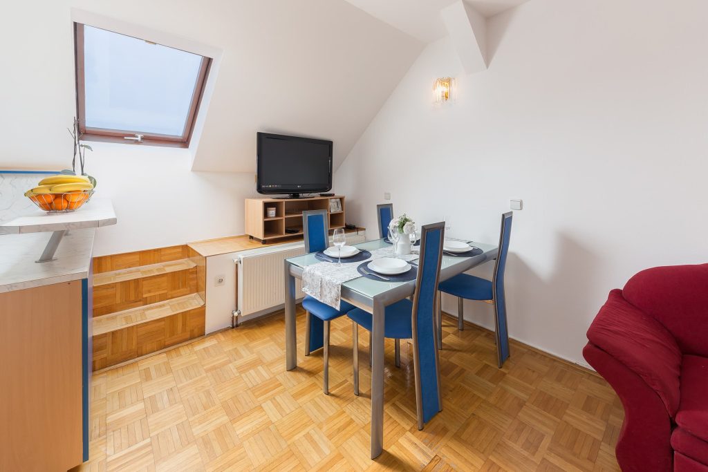 Beautifully furnished dining area with skylight