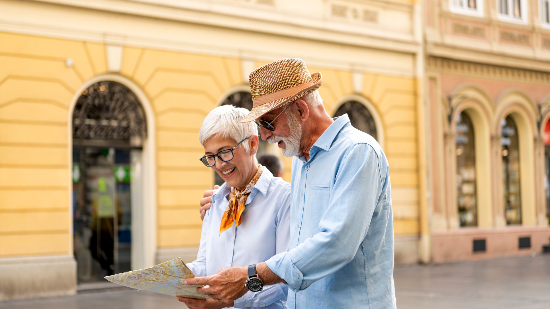 Two tourists explore the town and look at a map