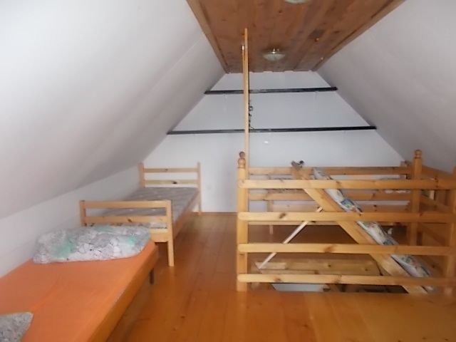 Preprosto in prijetno urejene sobe na podstrešju kmetije.