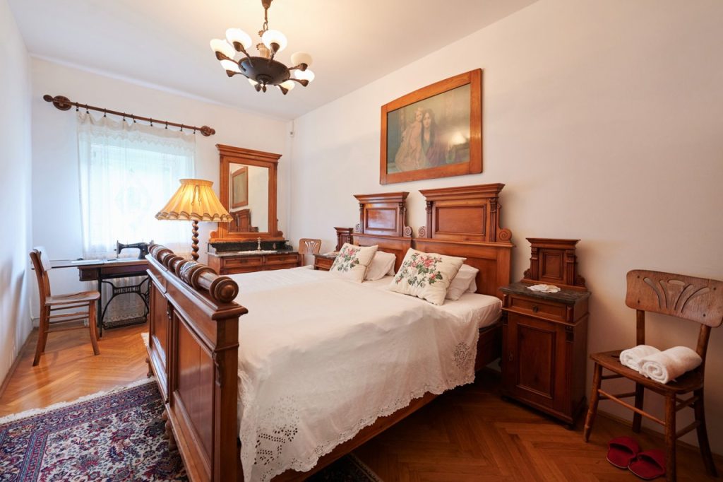 Grandma's Room at Bukovje Mansion – a romantically furnished bedroom with original early 20th-century furniture, preserving the ambiance of former castle living. 