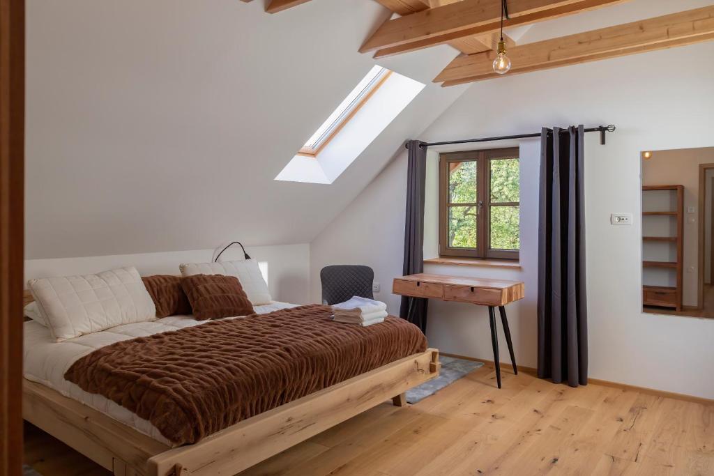 A pleasant and modernly furnished bedroom with a window and a skylight, filling the space with natural light.