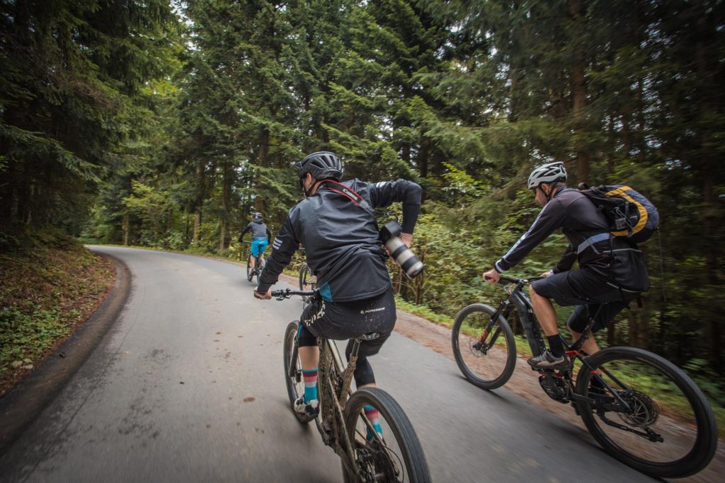 Group e-biking along the forest roads of Ribniško Pohorje as part of the Black Peak E-bike experience.