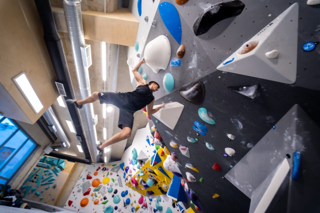 Climbing a wall using handholds.