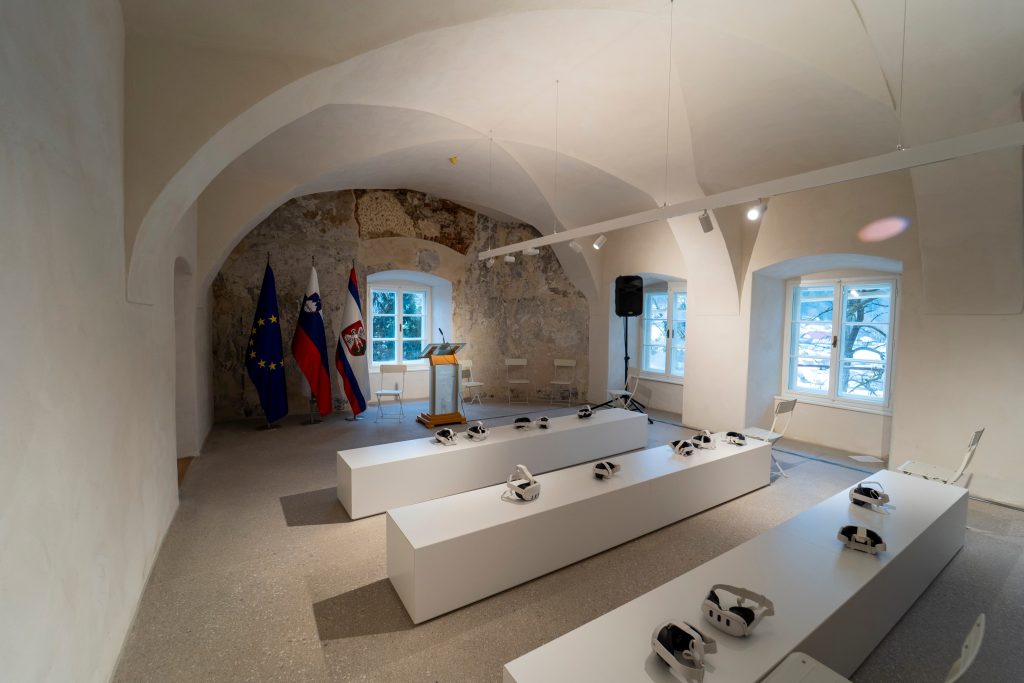 Interior of the manor with an exhibition setup, where glasses for viewing pre-recorded virtual content are placed on tables.