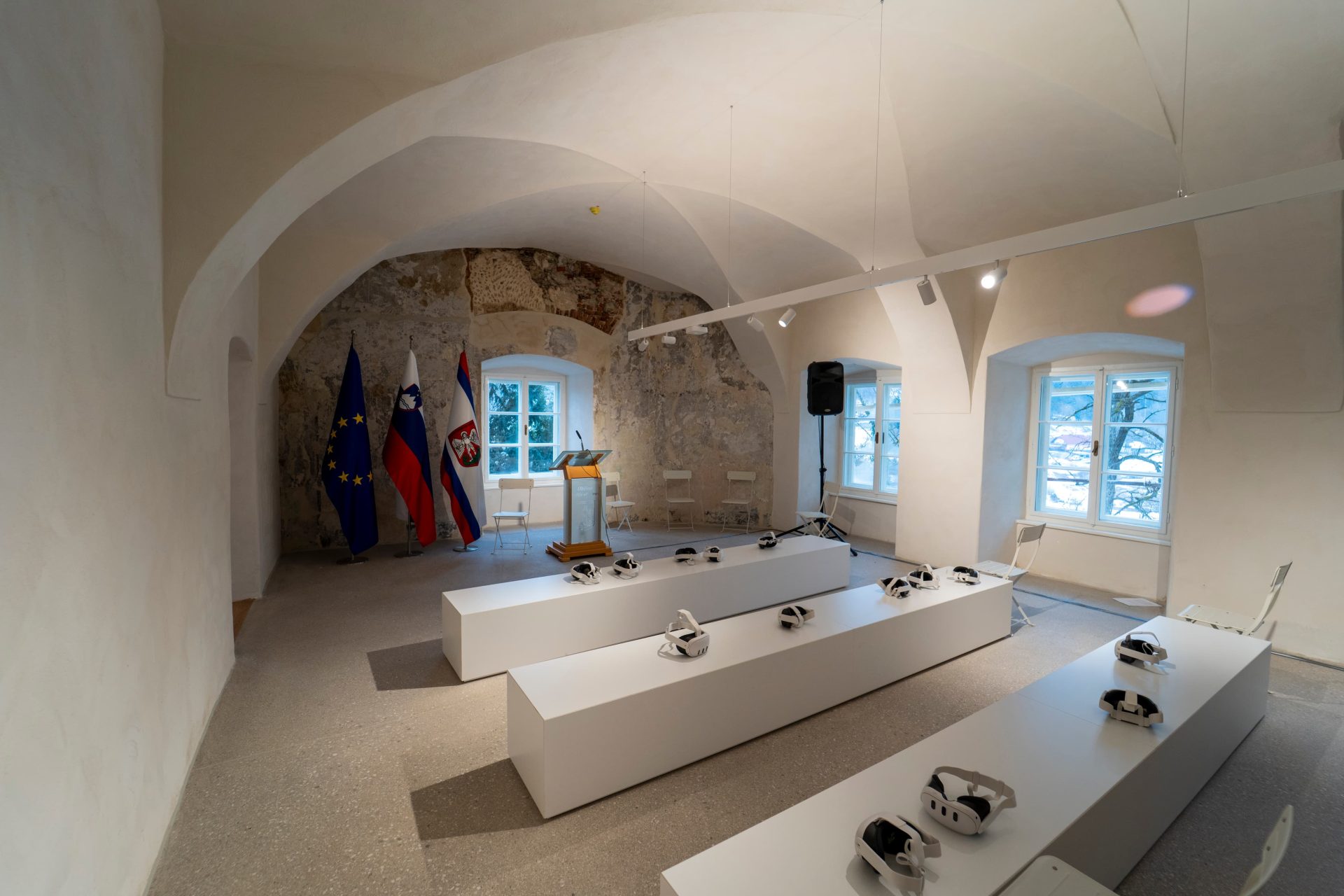 Interior of the manor with an exhibition setup, where glasses for viewing pre-recorded virtual content are placed on tables.