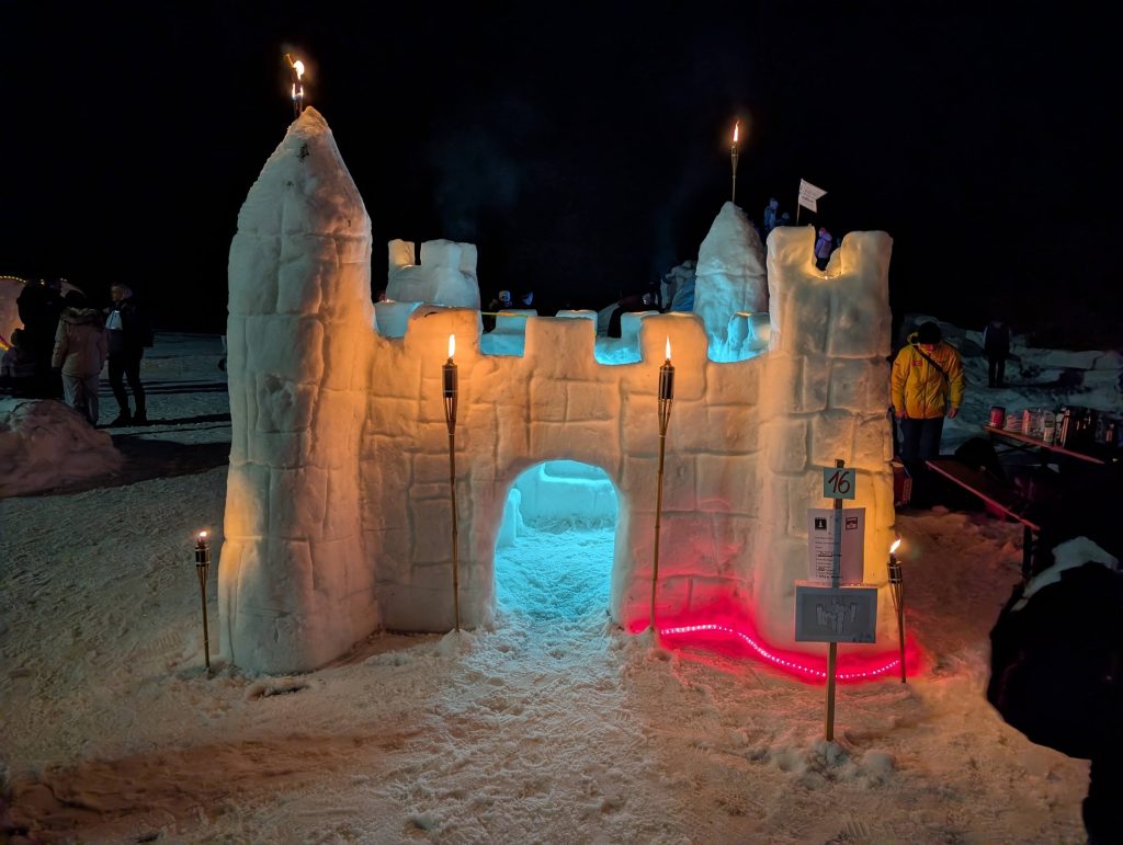 Snow castle in the evening glow of candles.