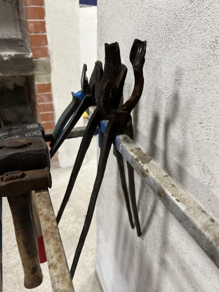 Blacksmith's tools in the workshop carefully arranged and ready for work.