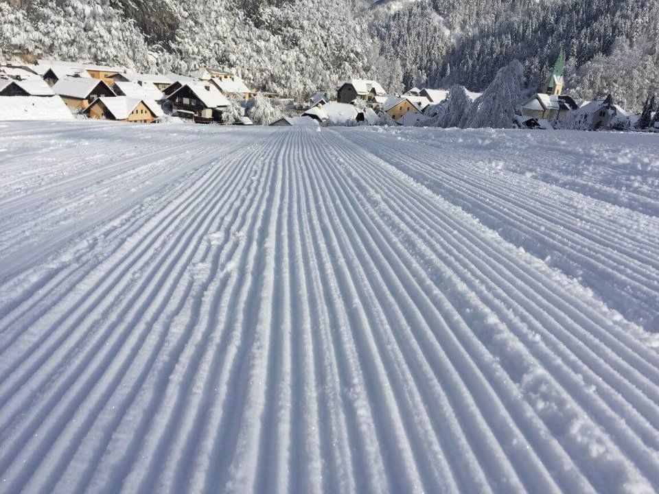 A snow-covered and well-groomed slope for winter fun.