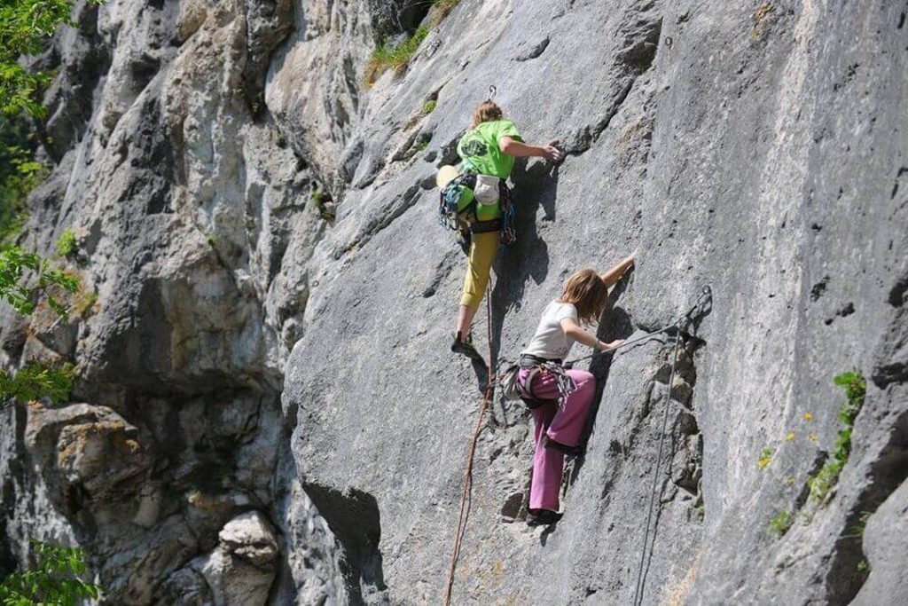 Climbers securely clipped in while ascending the rock.