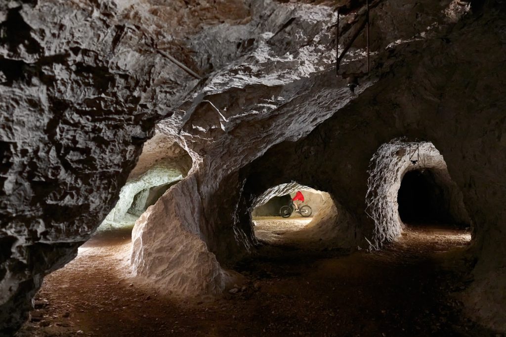 Cycling through abandoned mining tunnels beneath Peca.