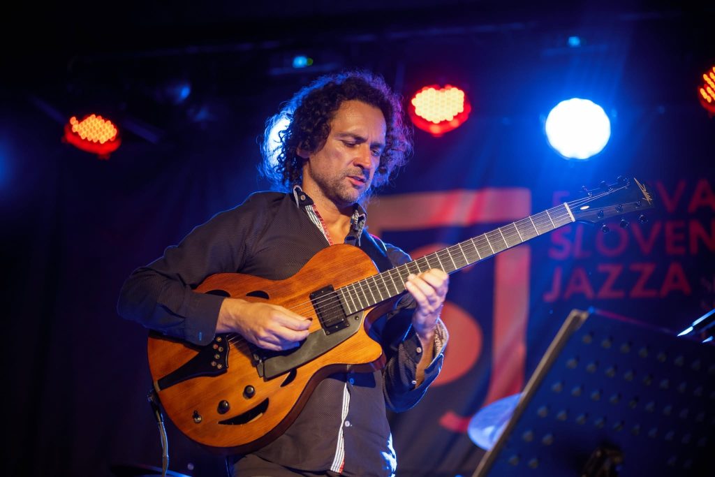 A guitarist’s solo performance under the festival stage lights.