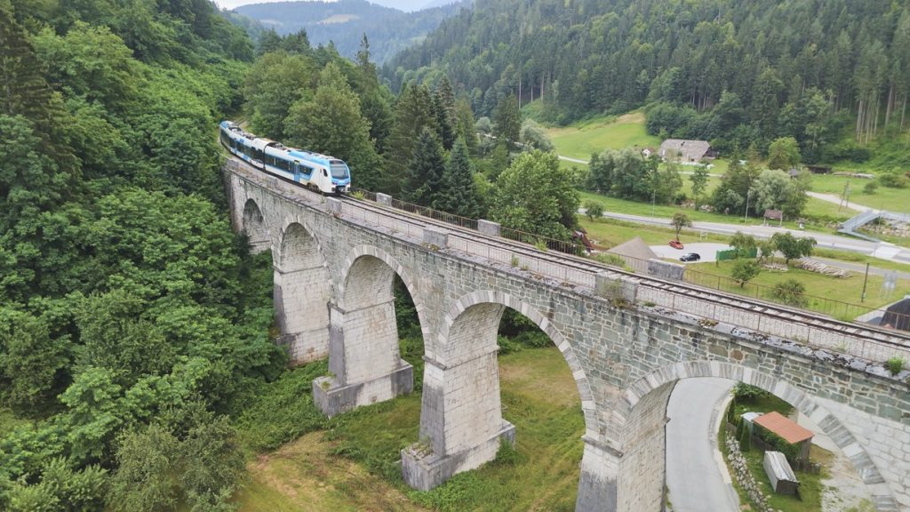 View of a train crossing a magnificent stone viaduct